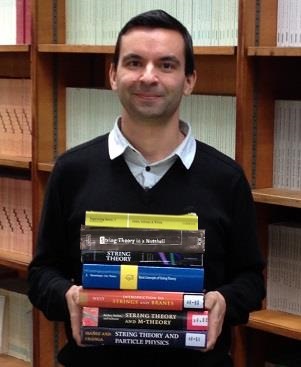 Photo of Panos Athanasopoulos holding string theory books